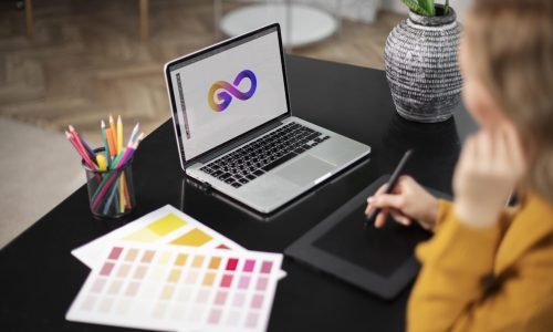 female-logo-designer-working-her-tablet-connected-laptop